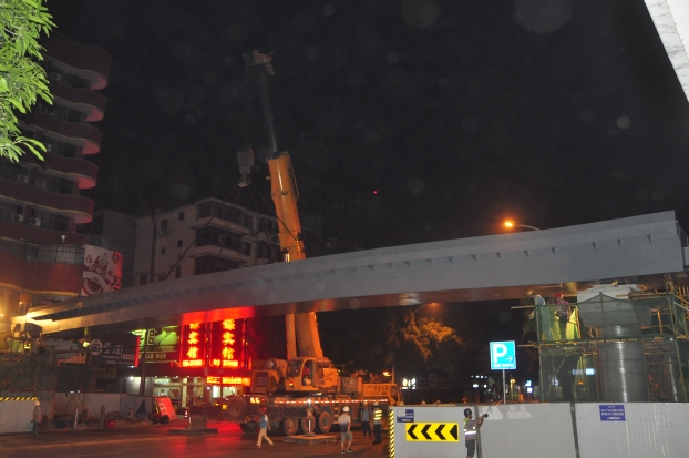 长38米、重达87吨的钢箱梁，，，，被200吨吊车稳稳地吊装在两个桥梁墩柱之上